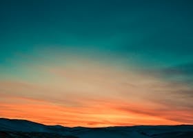 Sunset over Snow Covered Mountains